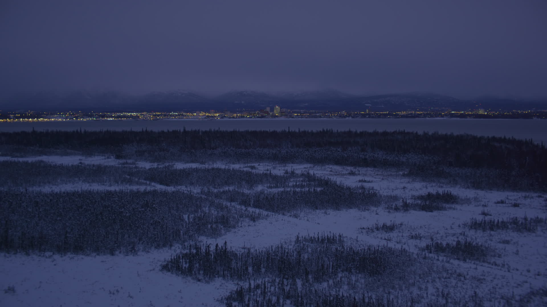 4K stock footage aerial video Downtown Anchorage skyline, snowy ground, Point MacKenzie, Alaska