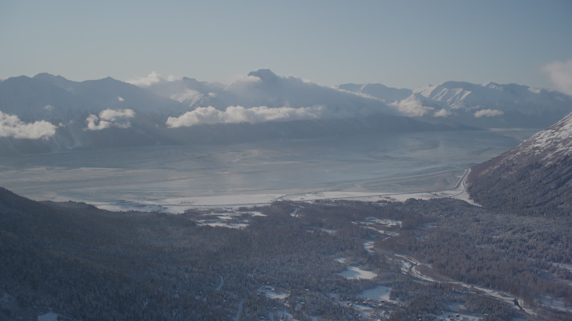 4K stock footage aerial video the snow covered Kenai Mountains with low