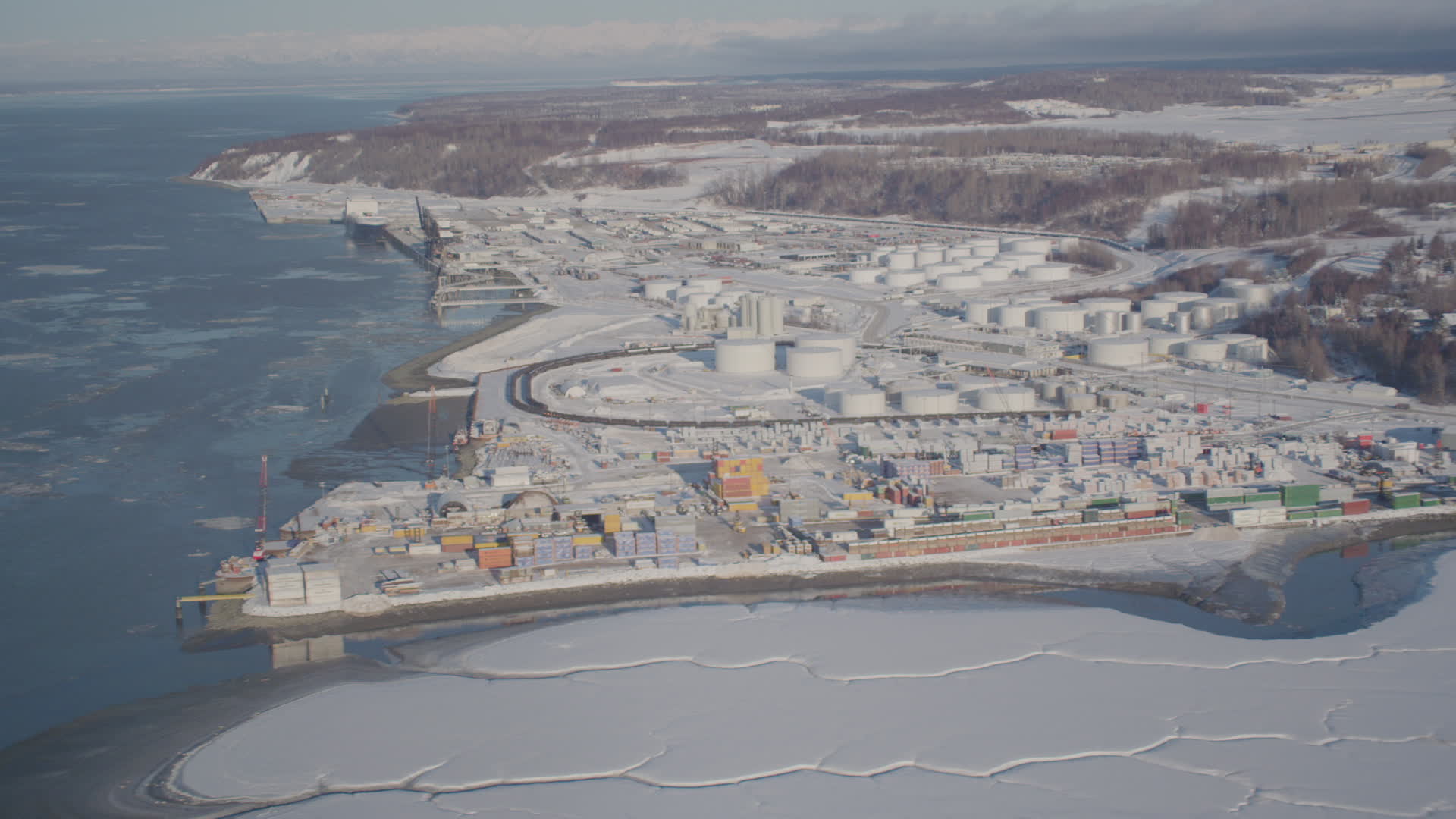 4K stock footage aerial video a snow covered oil refinery next to the