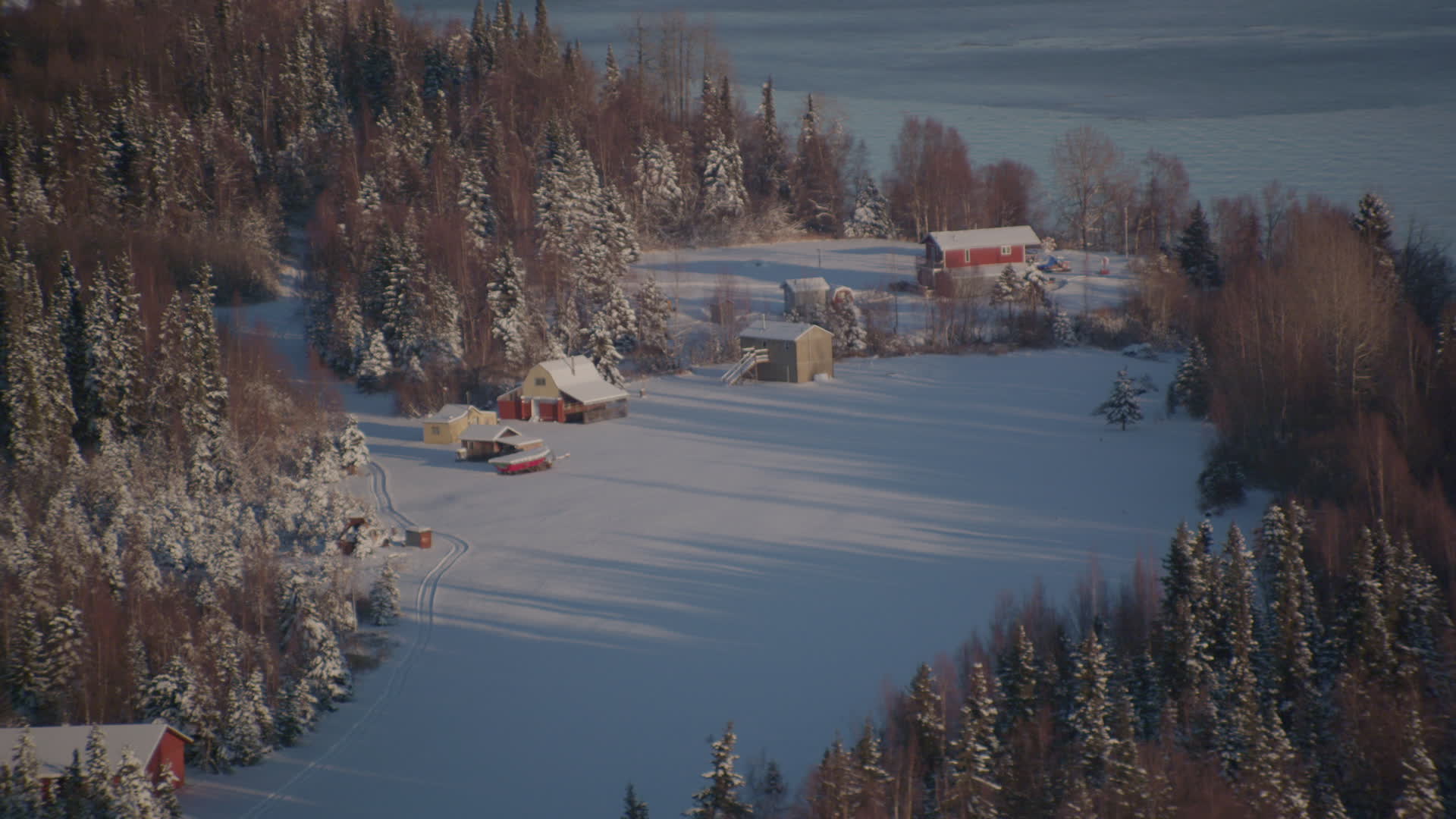 4K stock footage aerial video cabins in snowy woods in Point MacKenzie