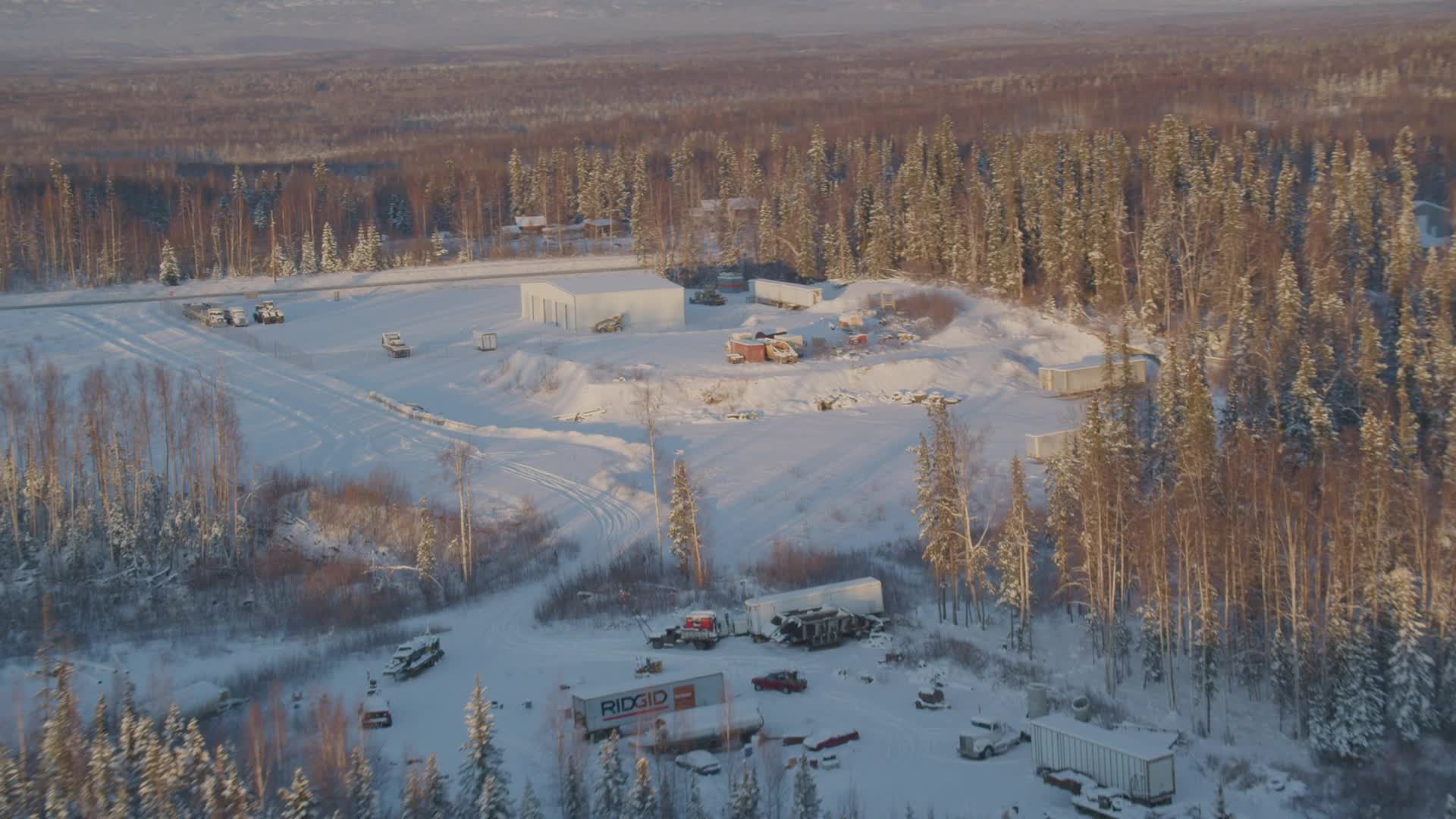 4K stock footage aerial video approach building surrounded by snowy