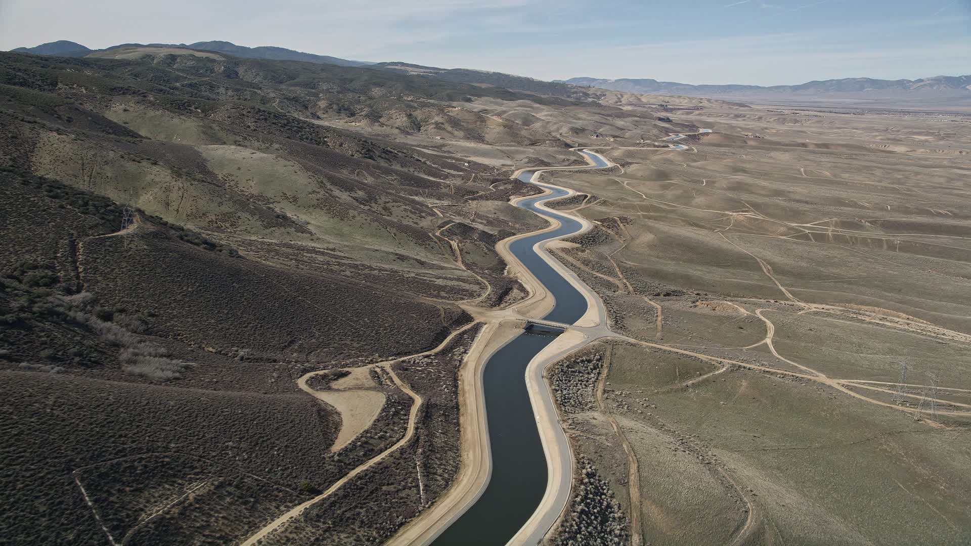 5K stock footage aerial video of California Aqueduct in the Mojave