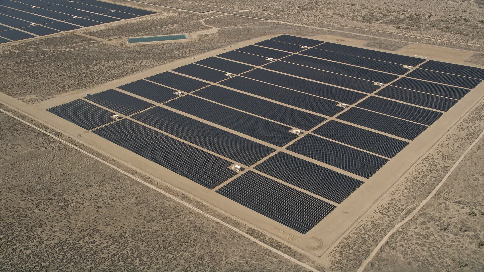 5K stock footage aerial video of solar panels at an energy array in the Mojave Desert