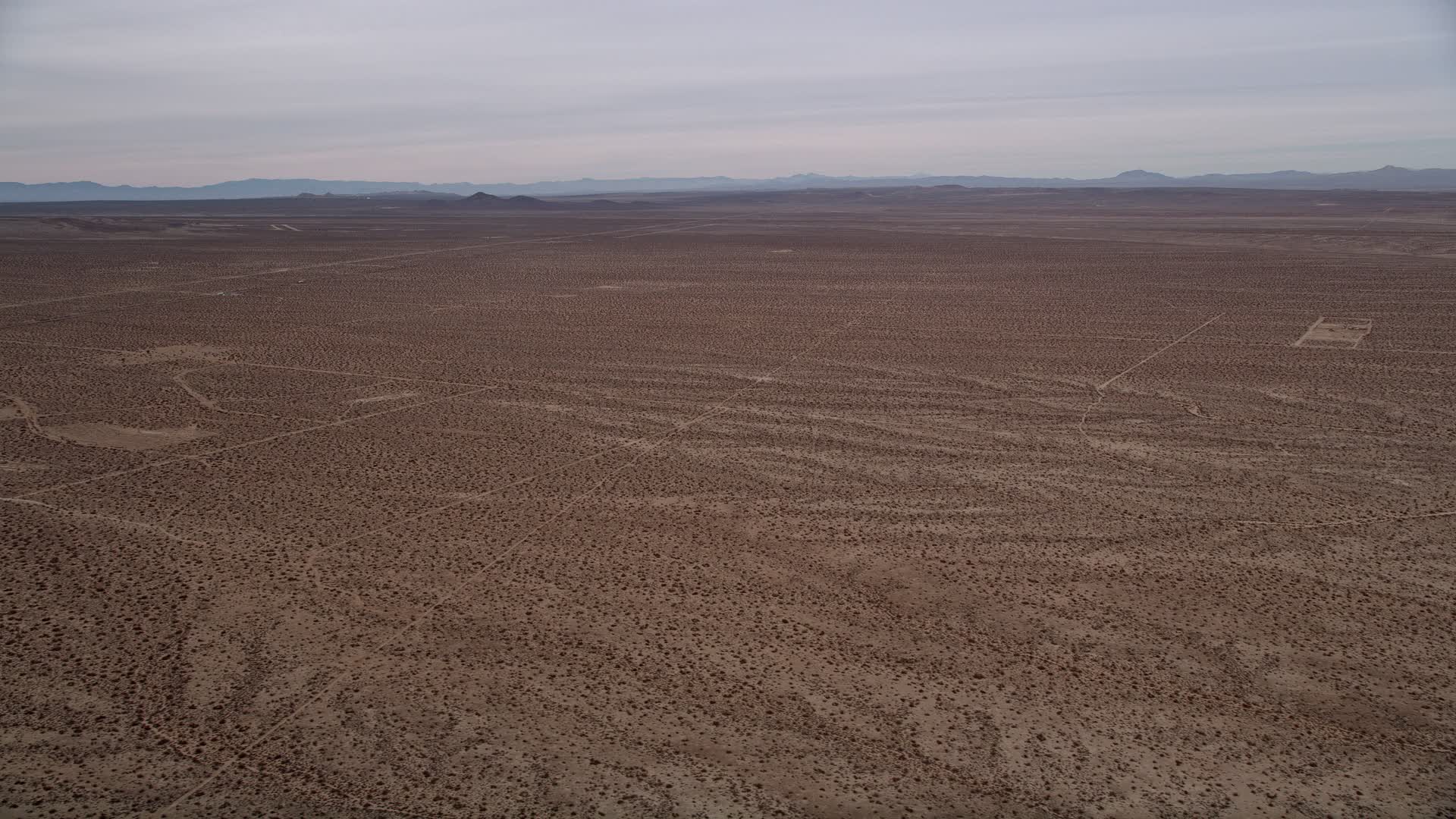 5K stock footage aerial video pan across open desert to reveal the