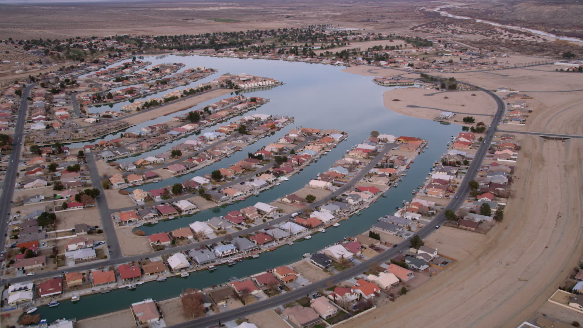 5K stock footage aerial video orbit lakeside homes in a small desert