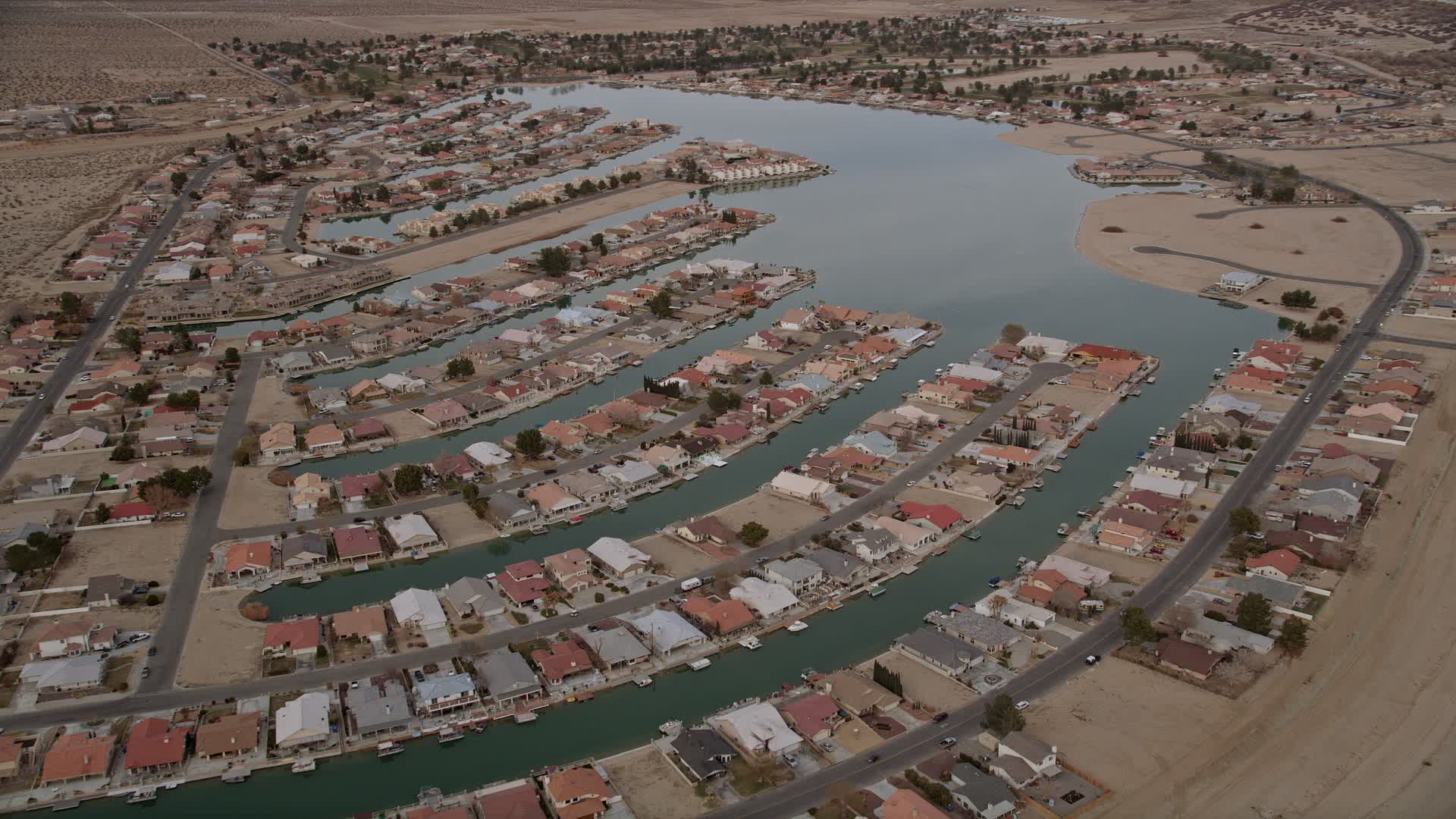 5K stock footage aerial video orbit lakeside homes in a small desert