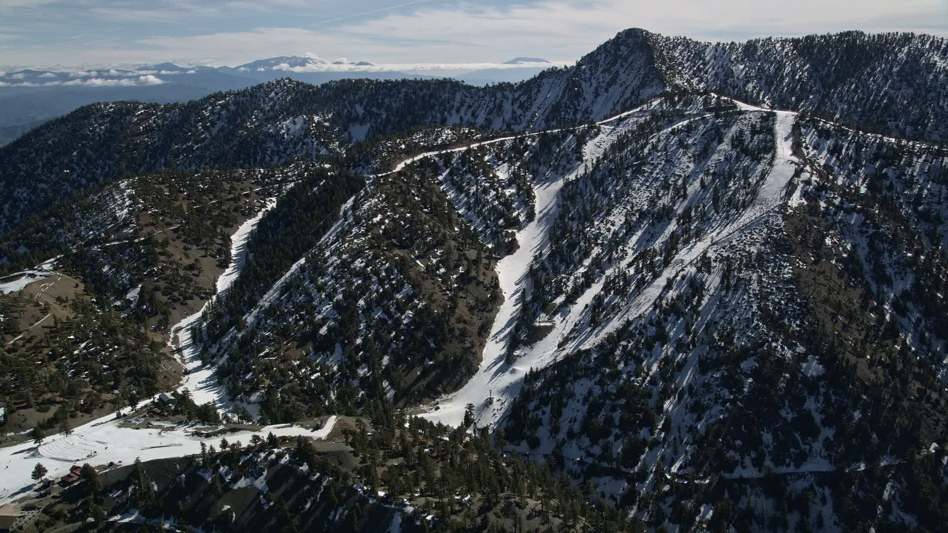 5K stock footage aerial video approach snowy slopes of Mount Baldy Ski