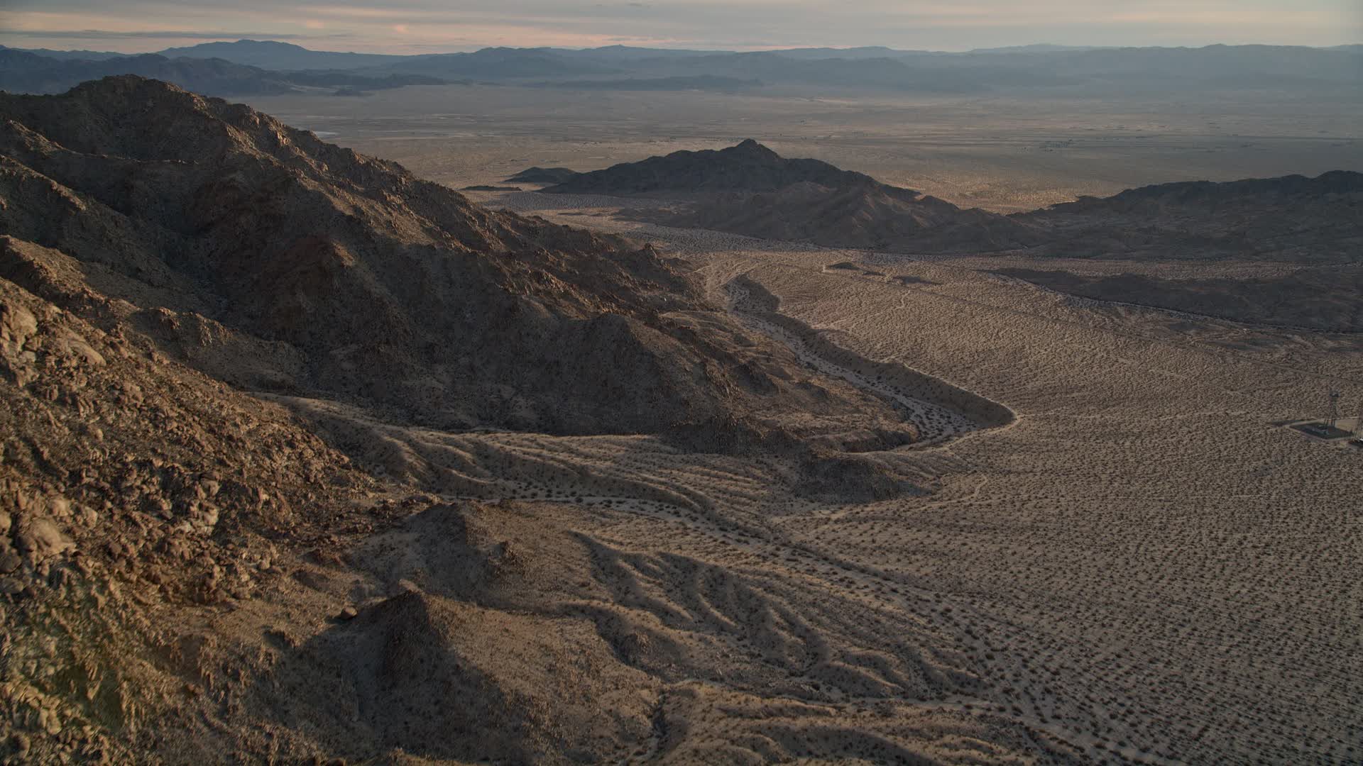 5K stock footage aerial video of mountain slopes and desert, Mojave
