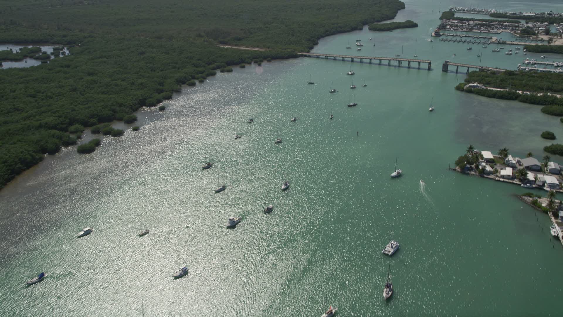 5K stock footage aerial video of flying by sailboats and fishing boats