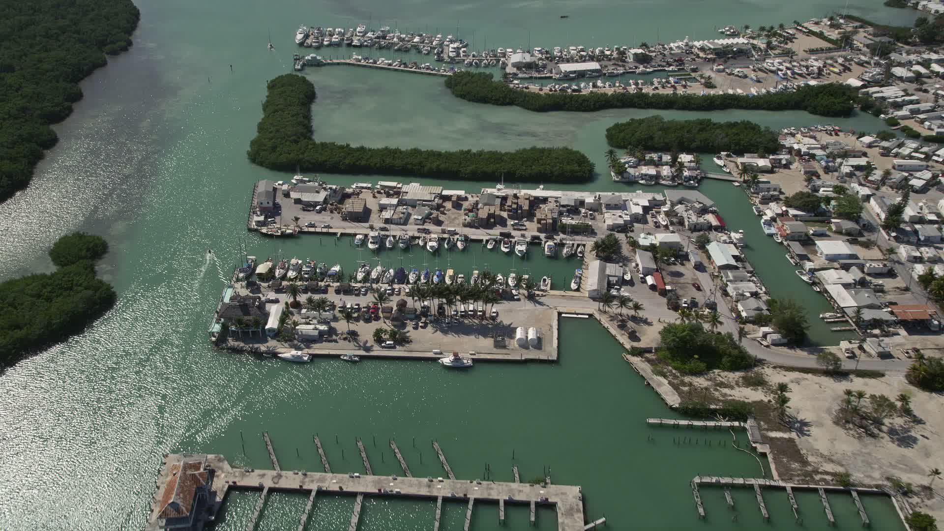 5K stock footage aerial video of boats docked at a coastal marina