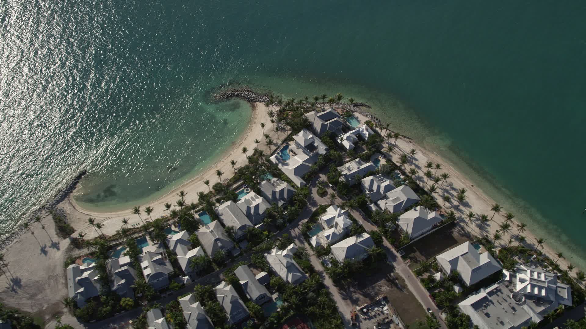 5K stock footage aerial video of flying by homes along the beach
