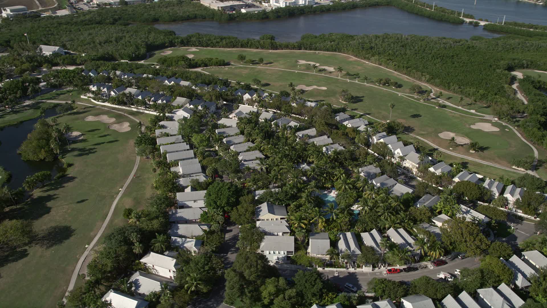 5K stock footage aerial video of flying by neighborhood, Key West Golf