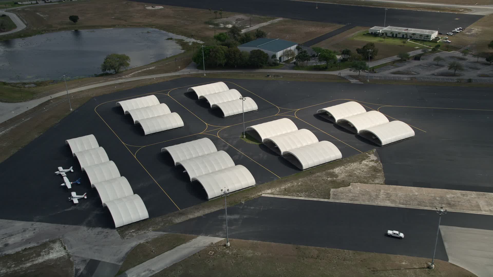 5K stock footage aerial video of flying over airplane hangers, Orlando