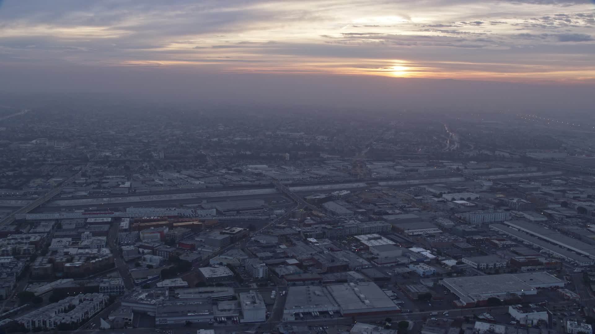 7.6K stock footage aerial video flying over downtown warehouse buildings to approach the LA