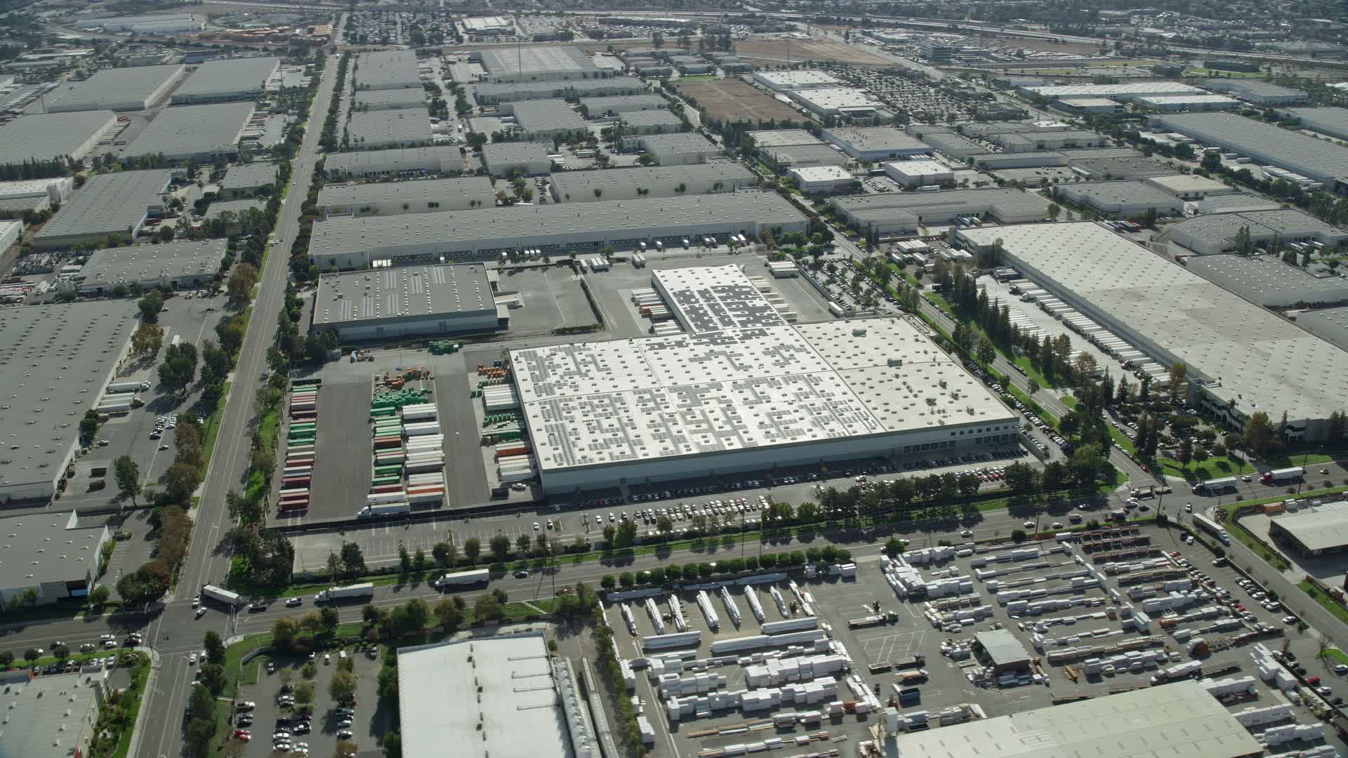 7.6K stock footage aerial video flying over large warehouses in Chino