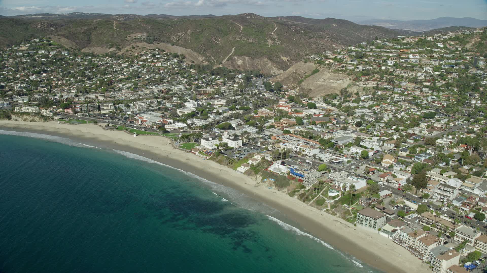 7.6K stock footage aerial video flying over ocean, beach and houses