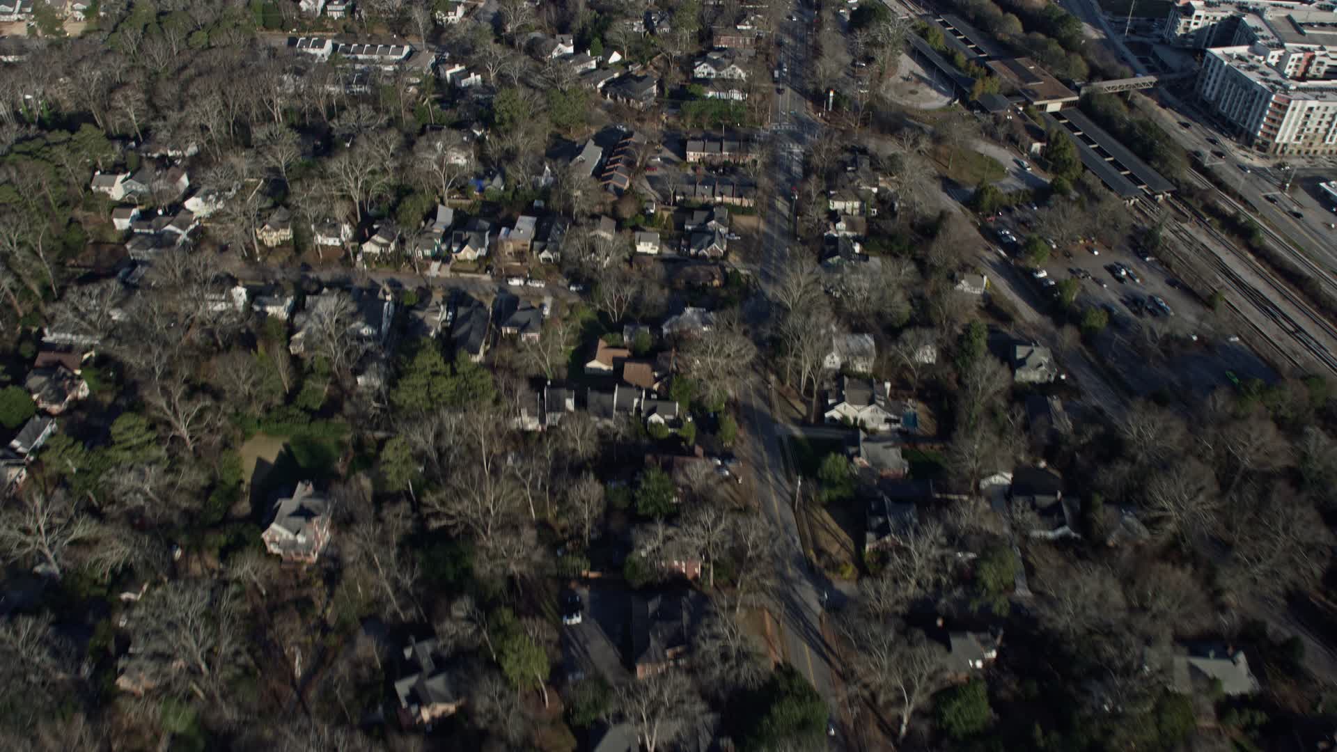 4K stock footage aerial video following a road through a suburban neighborhood in Decatur