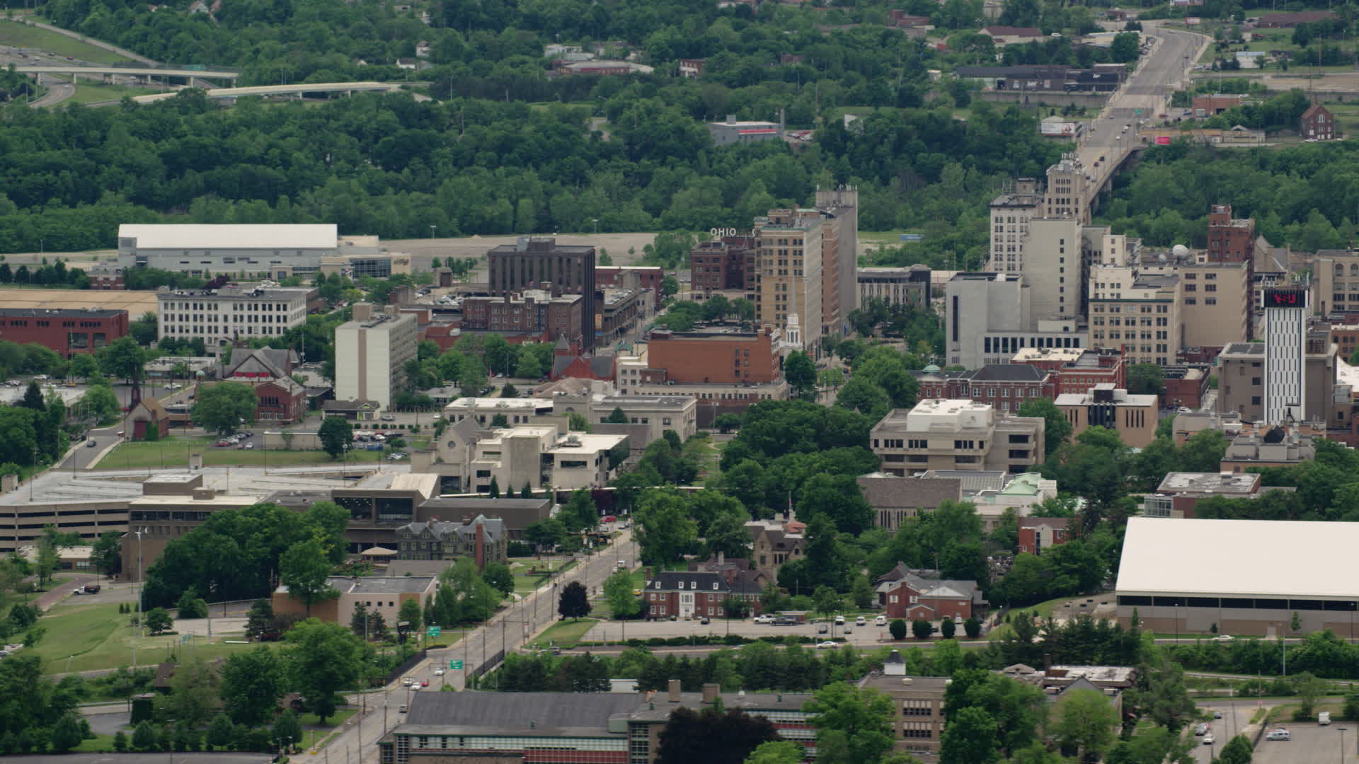 5K stock footage aerial video orbiting the campus of Youngstown State
