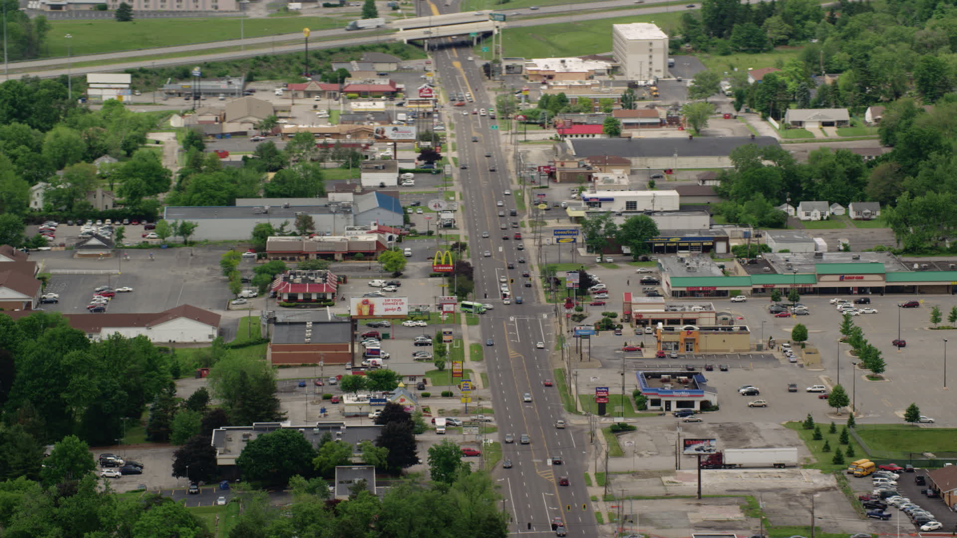 5K stock footage aerial video shops and strip mall by busy street in