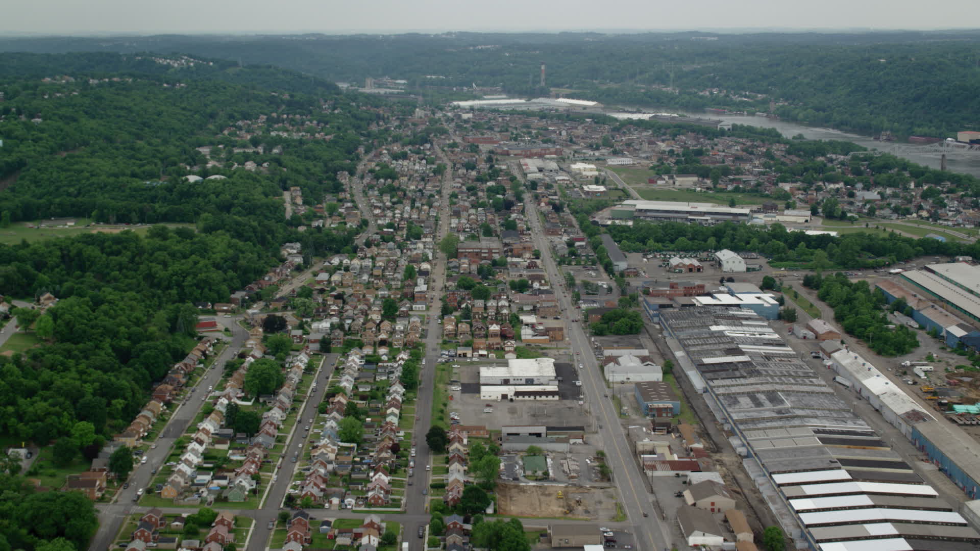 4.8K stock footage aerial video flying over homes and small factories