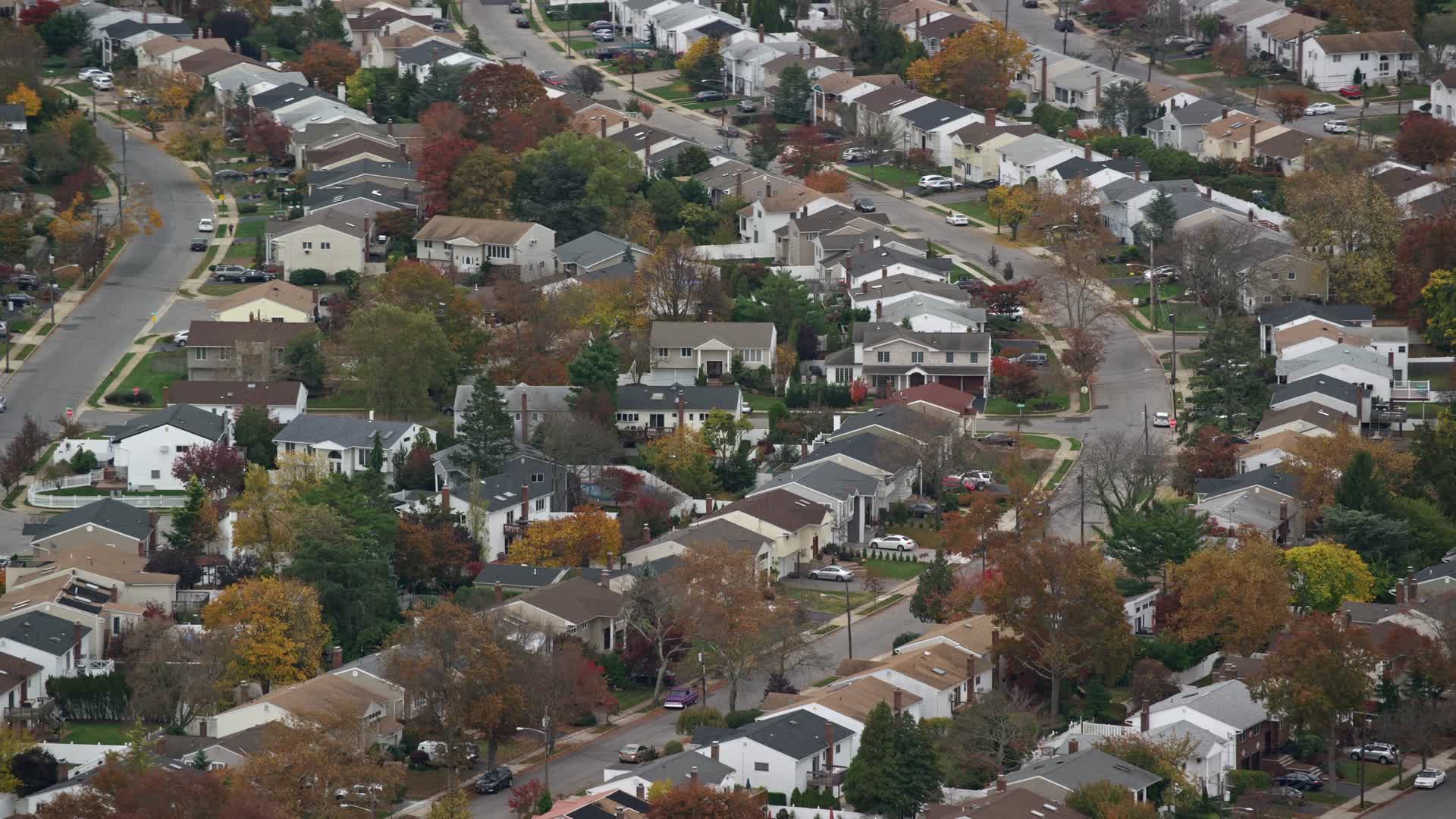 5.5K stock footage aerial video of an orbit of suburban homes in Autumn