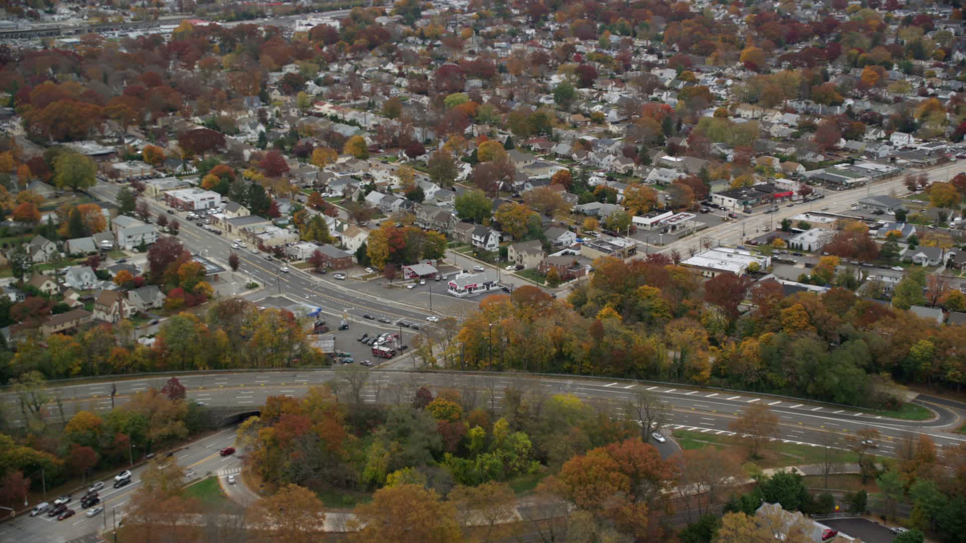 6K stock footage aerial video of shops and suburban homes in Autumn