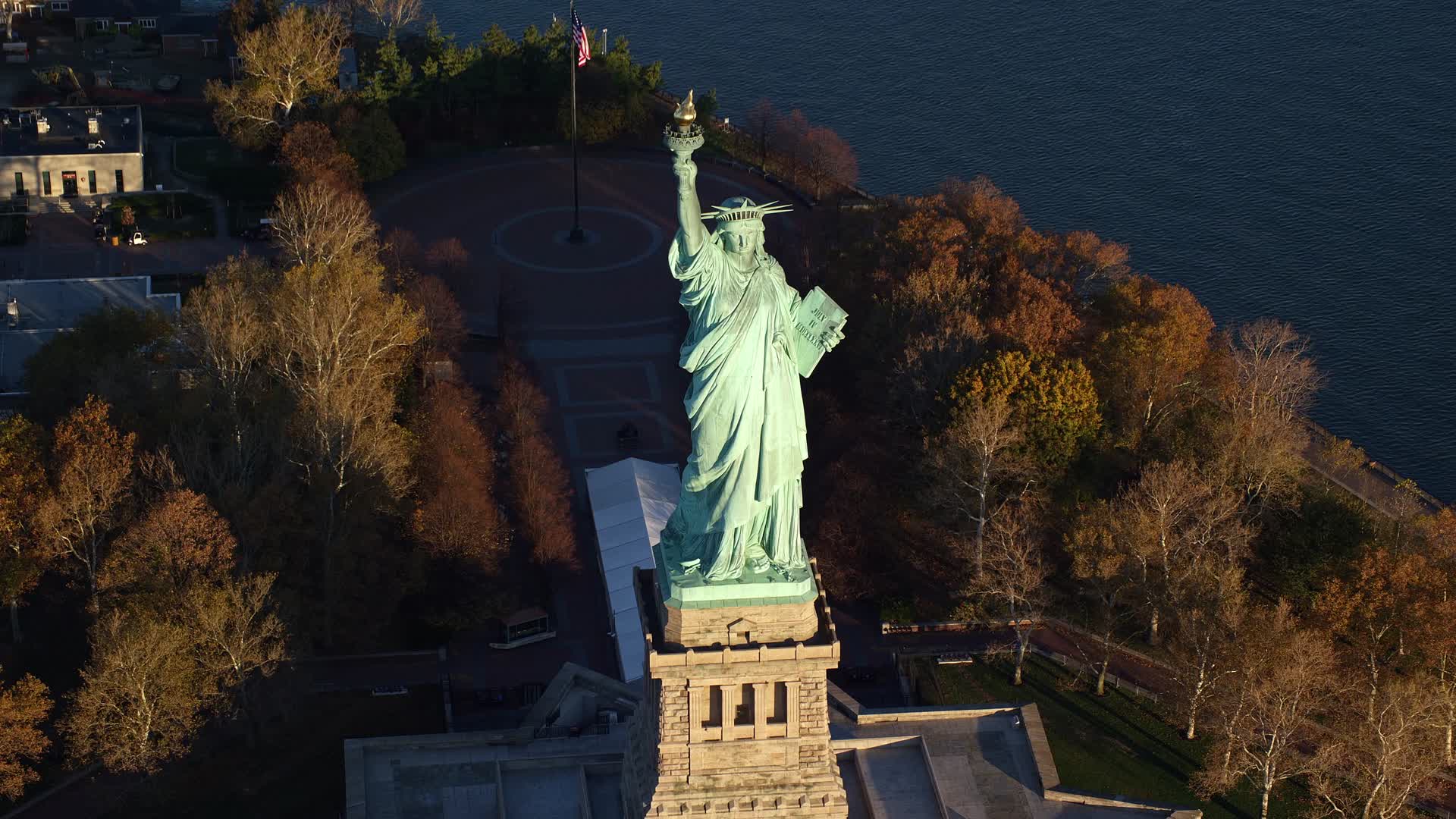 5.5K stock footage aerial video approach and tilt to bird's eye of the Statue of Liberty at