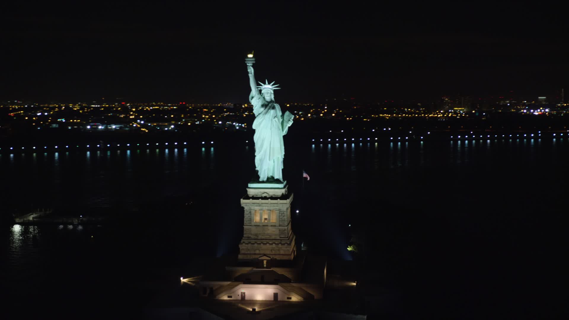 5.5K stock footage aerial video orbit the front of the Statue of Liberty at Night in New York