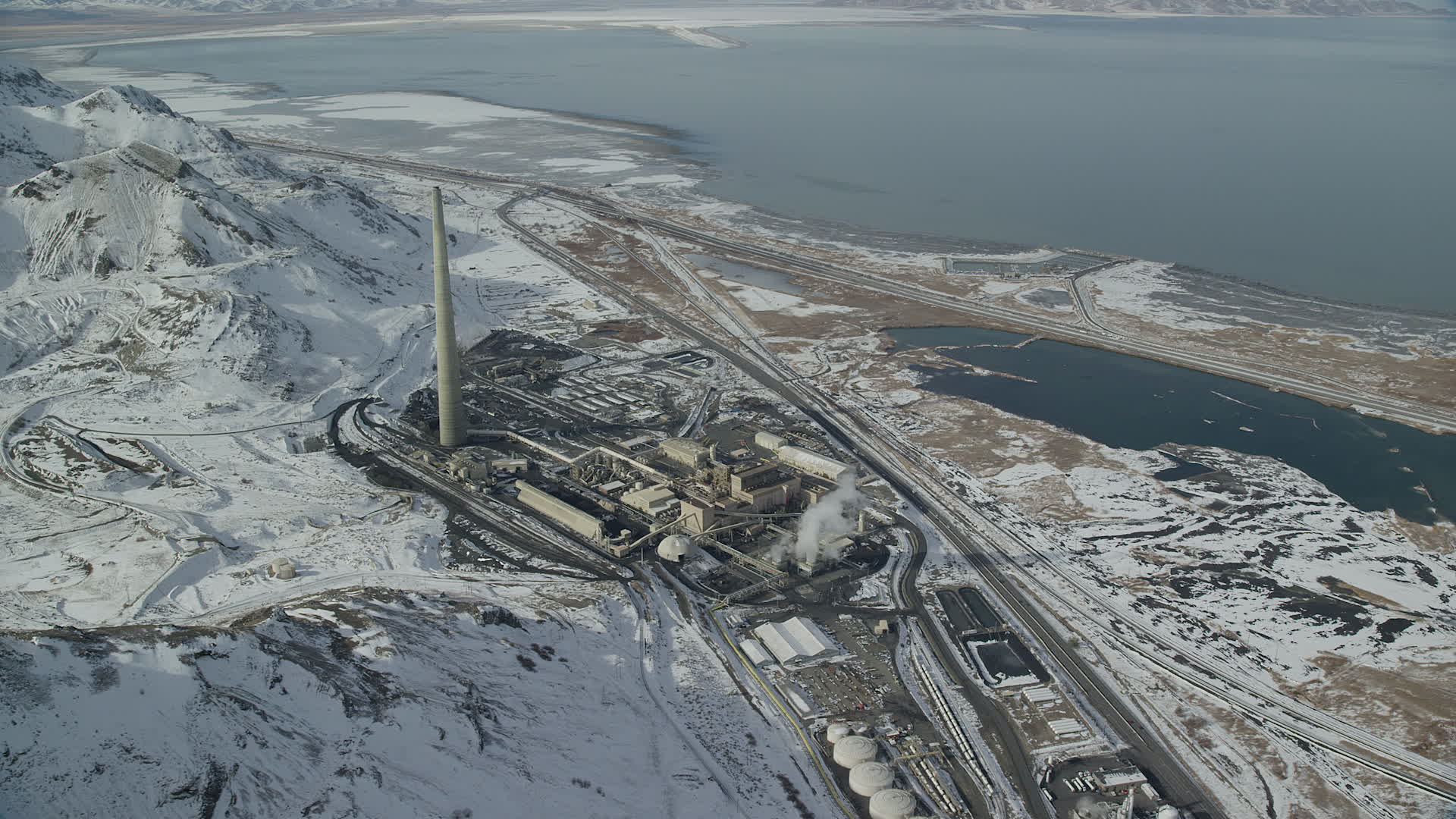 5.5K stock footage aerial video orbit factory buildings and Kennecott