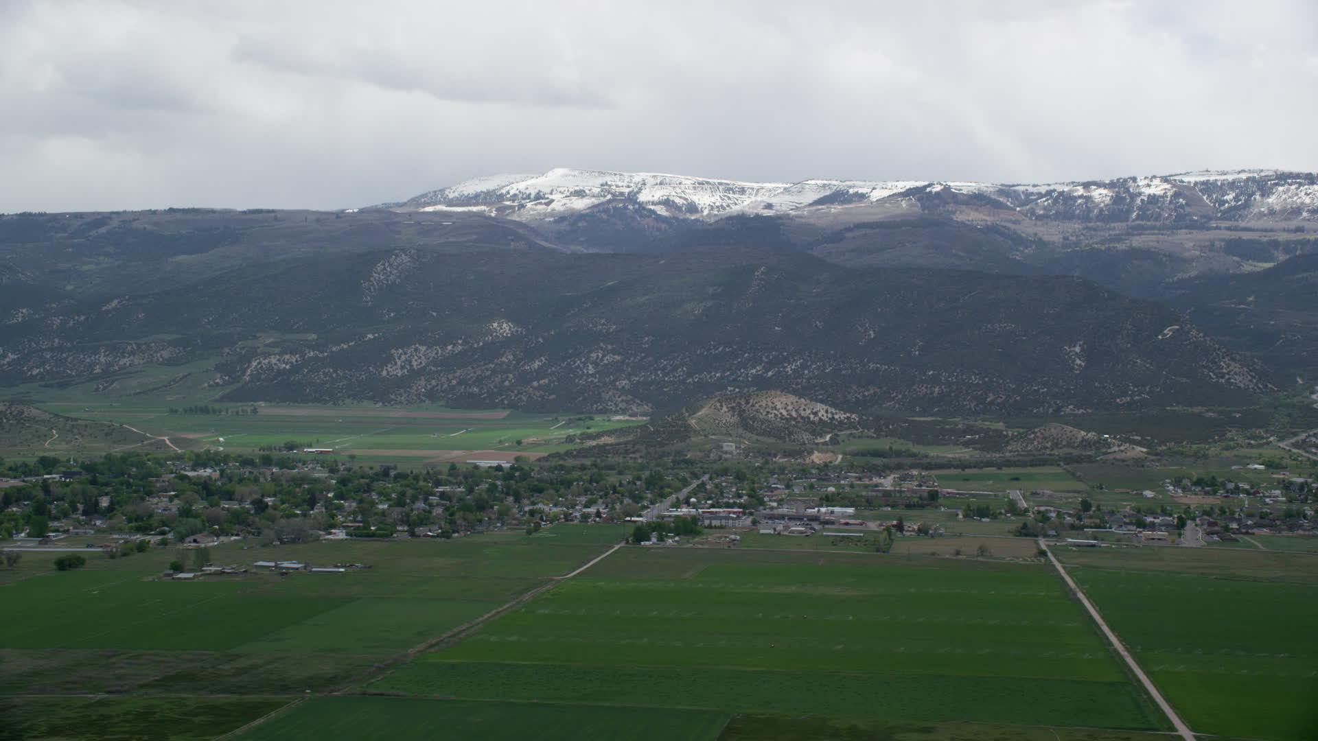 6K stock footage aerial video of passing small rural town, Wasatch