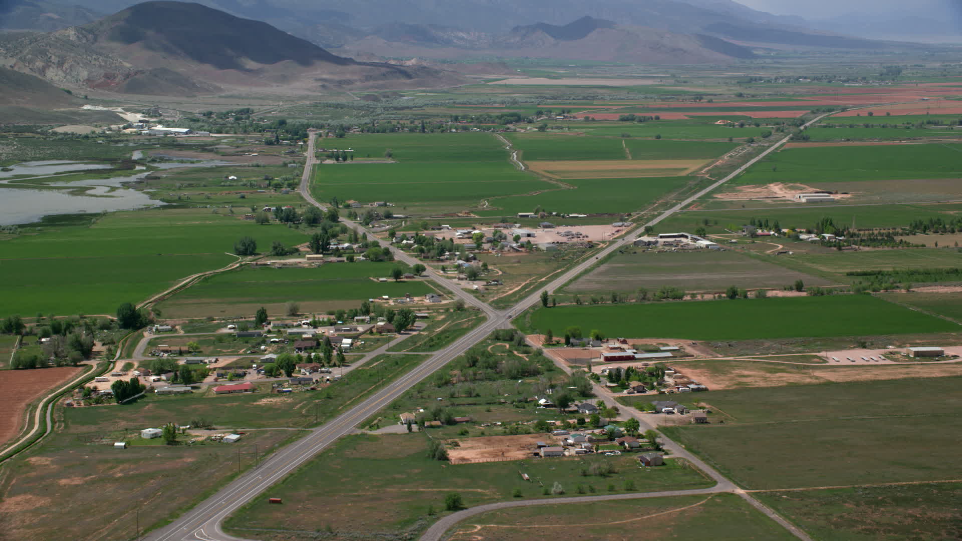 6K stock footage aerial video of flying by rural town, pan to Rocky