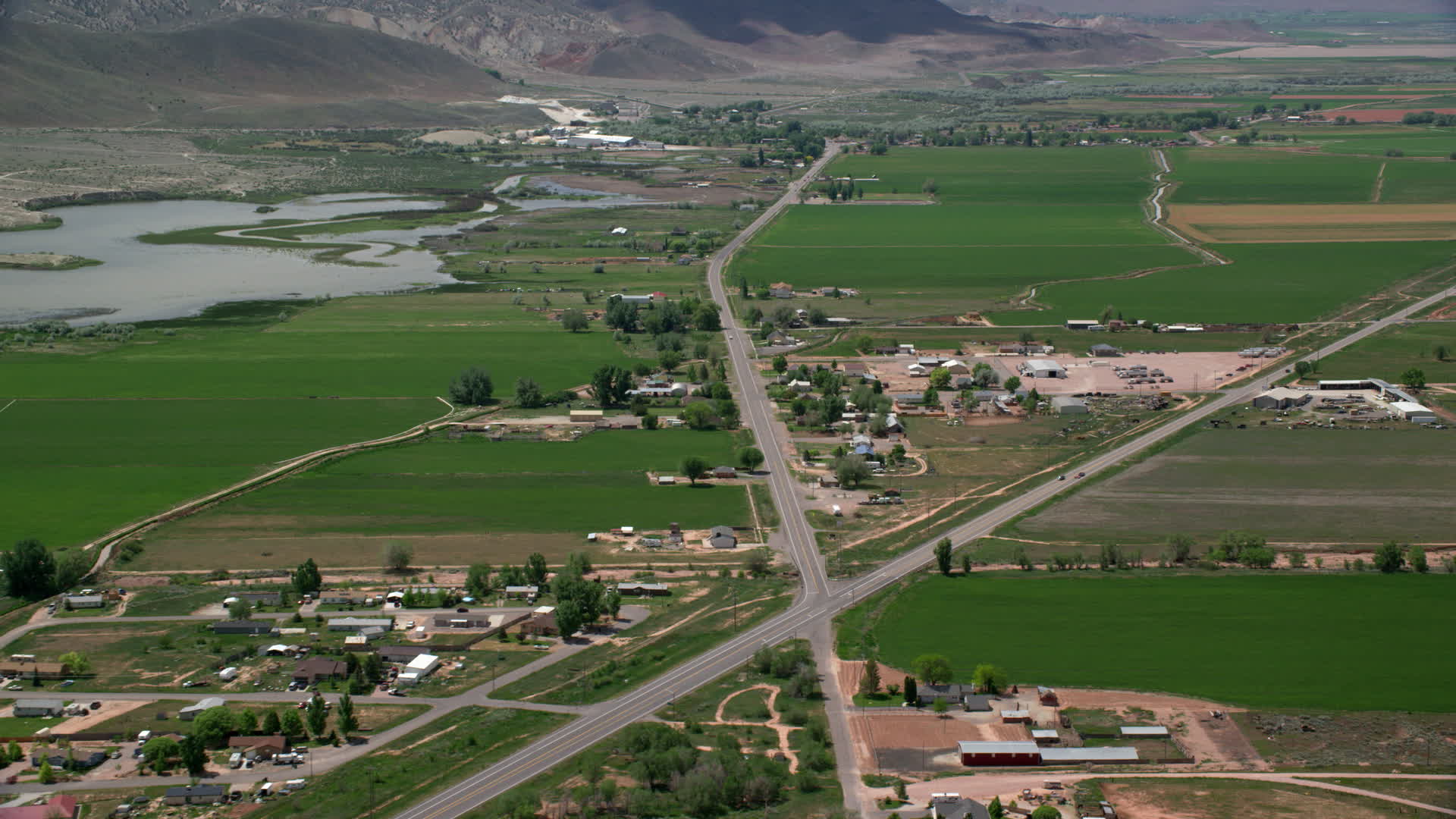 6K stock footage aerial video of passing by rural town, farmland, Rocky