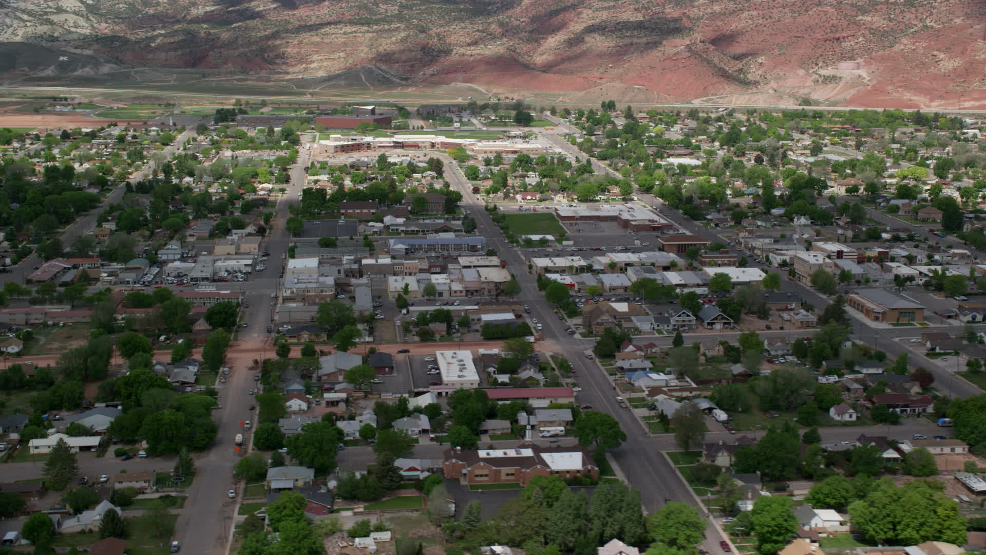 5.5K stock footage aerial video of passing by shops, small town