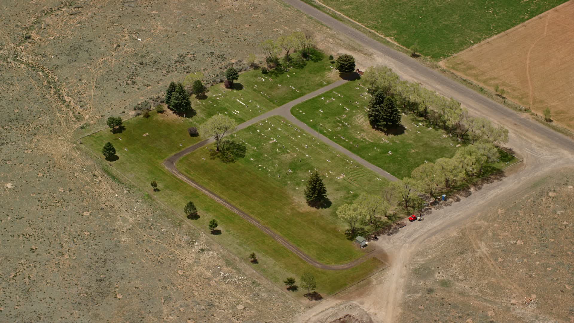 5.5K stock footage aerial video of orbiting a tiny cemetery by rural