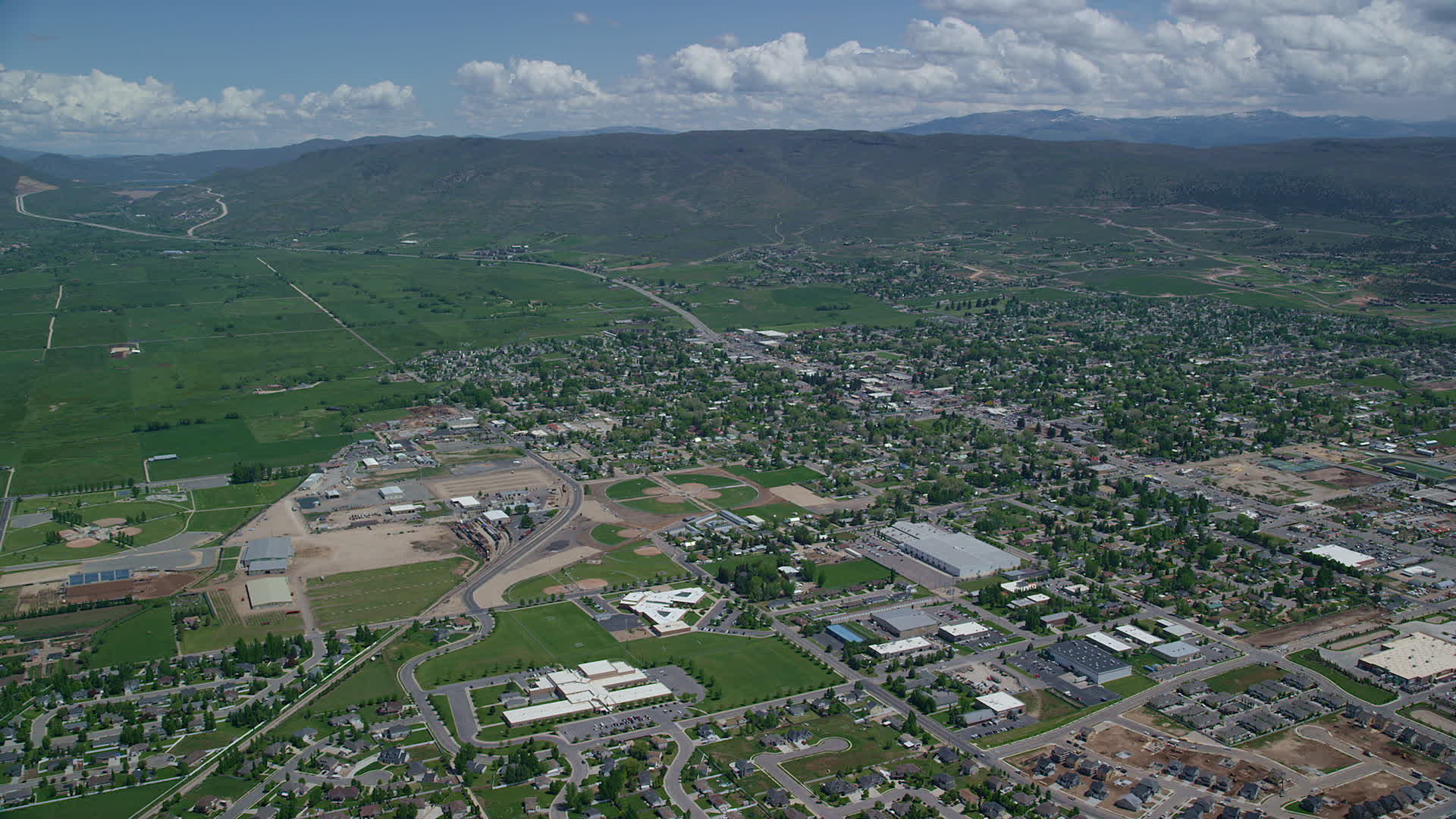6K stock footage aerial video of approaching small town, pan across