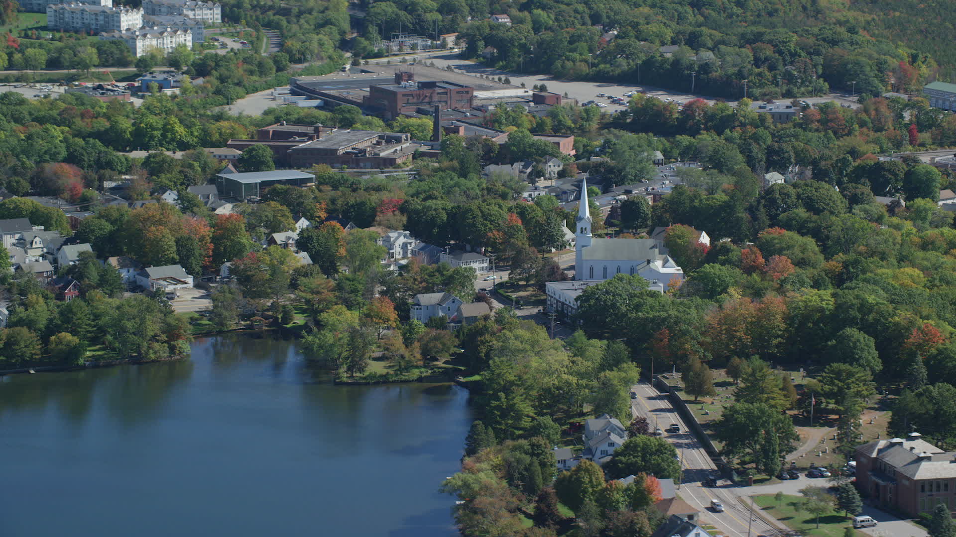 5.5K stock footage aerial video flying by small town with waterfront