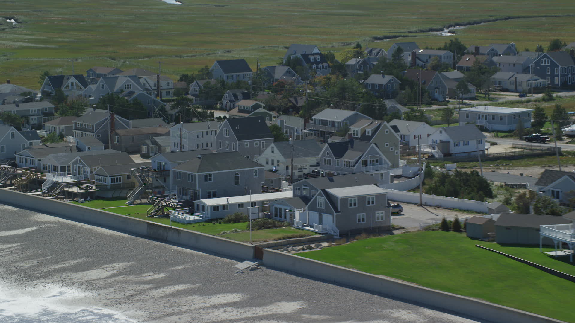 5.5K stock footage aerial video approaching beachfront homes, tilting