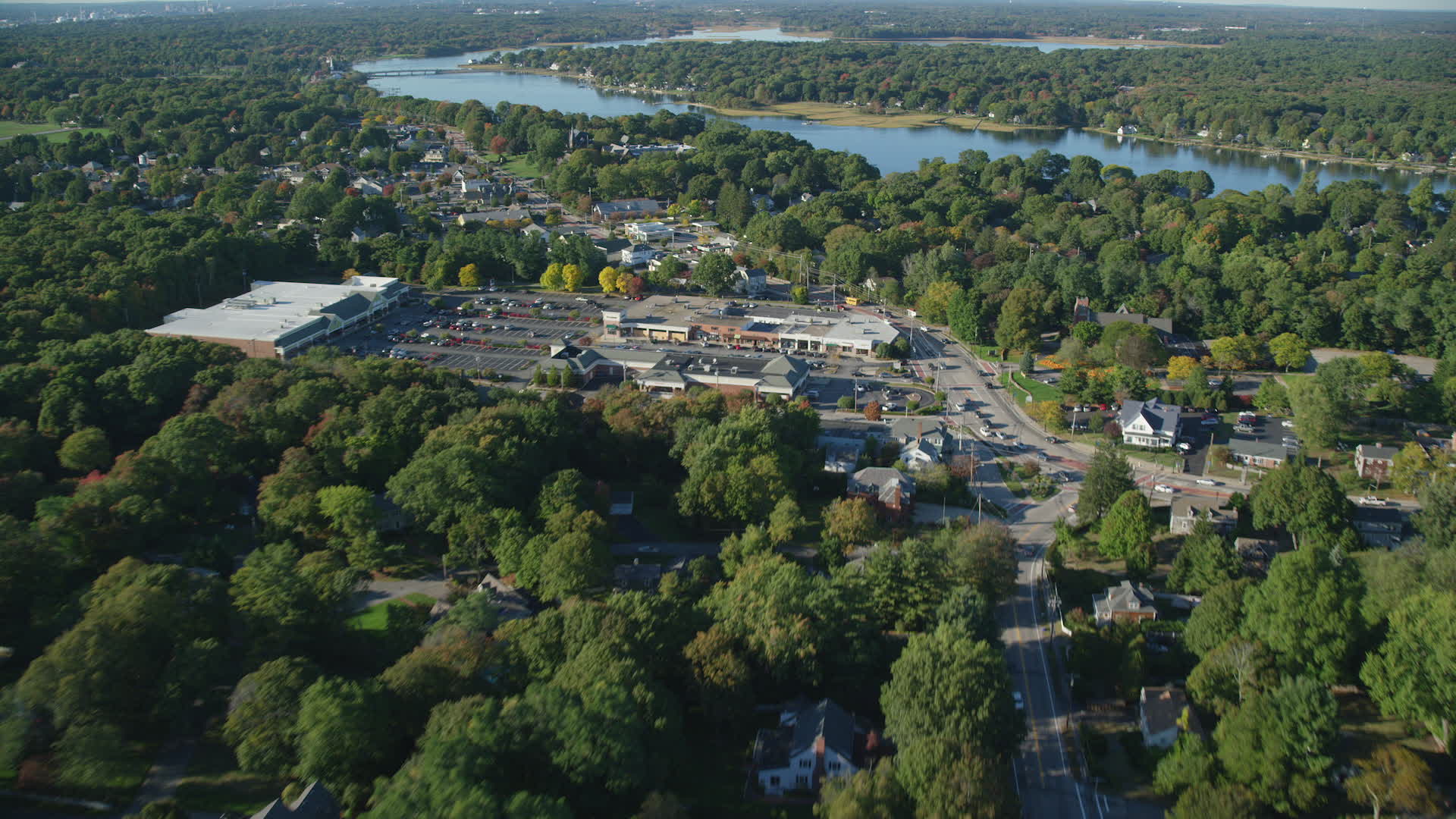 6k stock footage aerial video flying over County Road, approaching strip mall, Barrington, Rhode