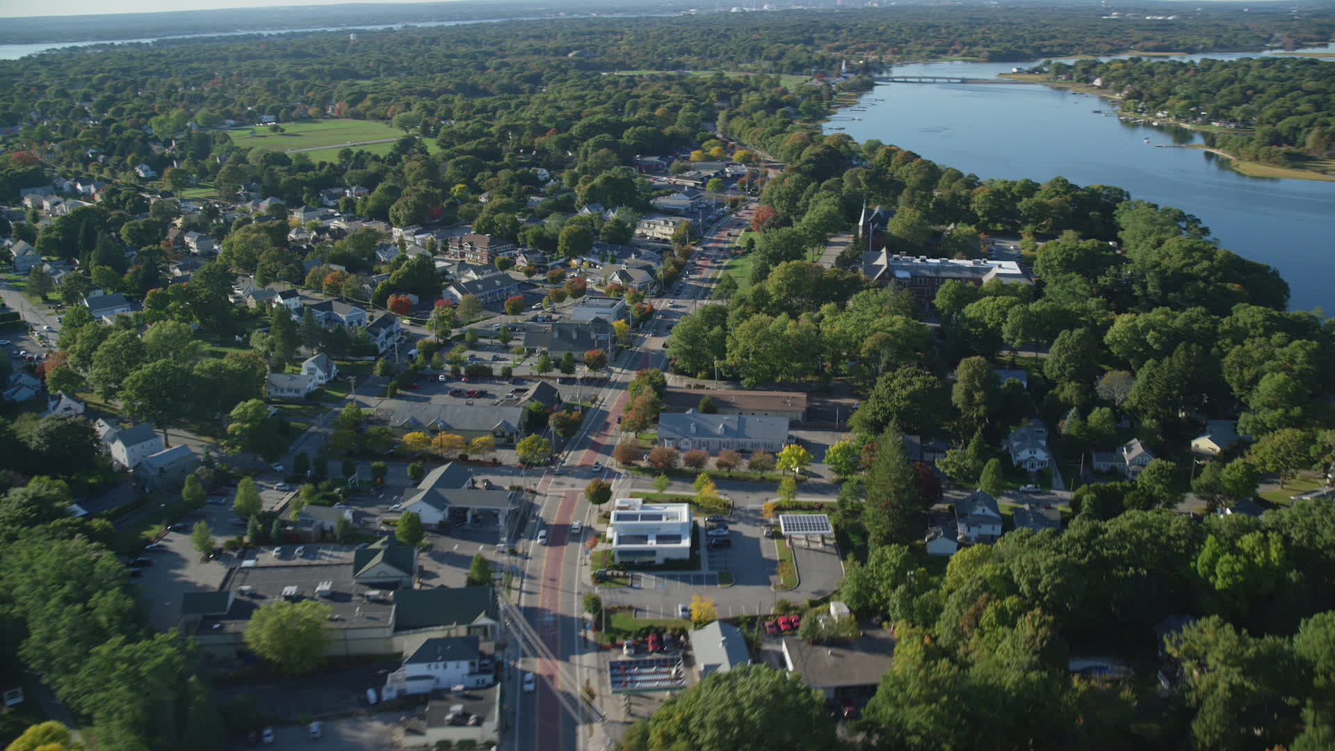 6k stock footage aerial video flying by County Road, neighborhoods, shops, Barrington, Rhode