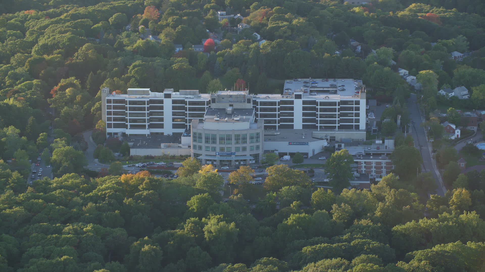 6k stock footage aerial video flying by Faulkner Hospital in autumn, Jamaica Plain