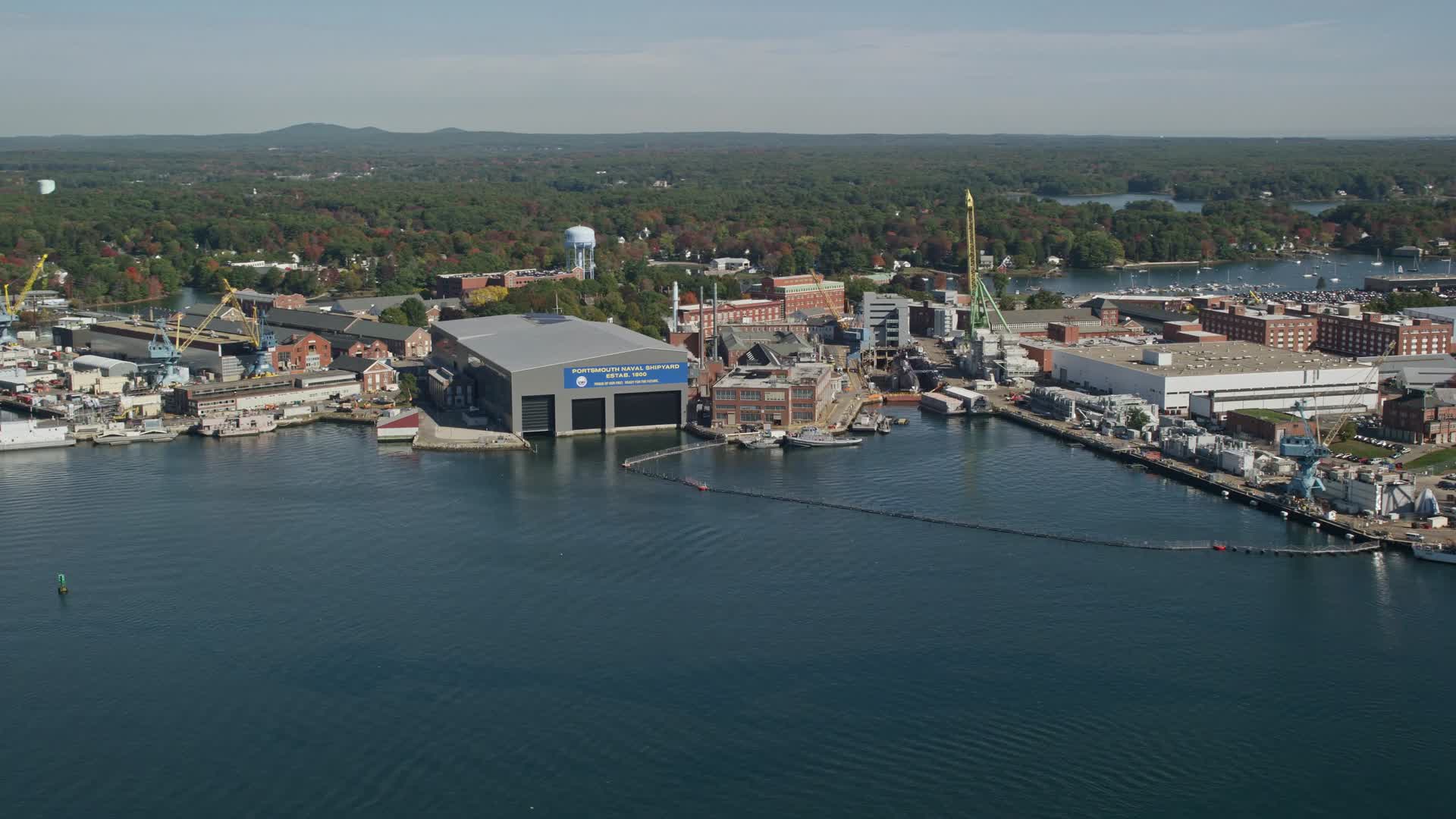 6k stock footage aerial video flying by a naval shipyard in autumn