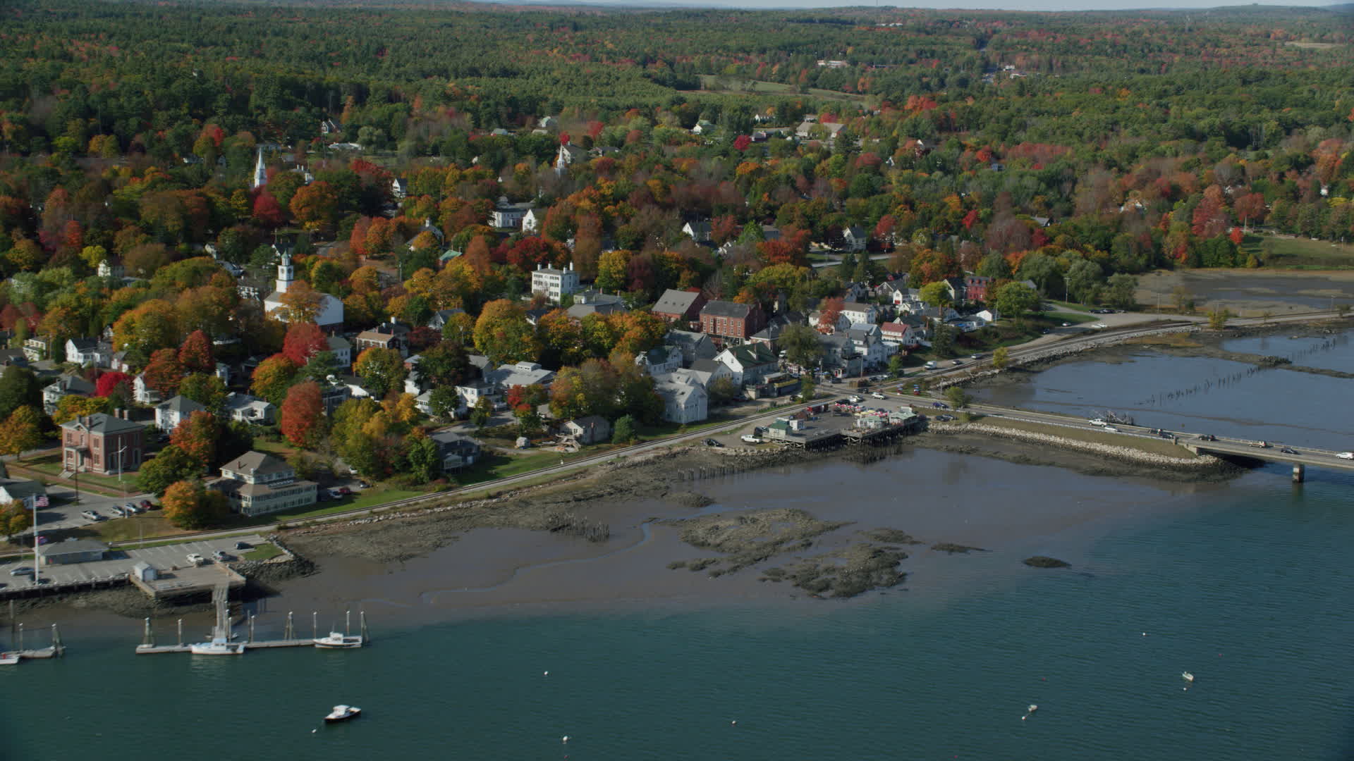 6k stock footage aerial video approaching small waterfront town, tilt down, Main Street, autumn