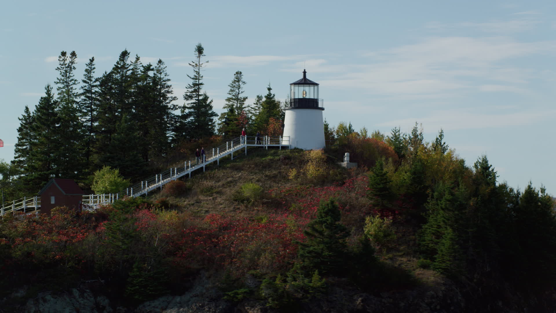 6k stock footage aerial video orbiting Owls Head Light, fall foliage in