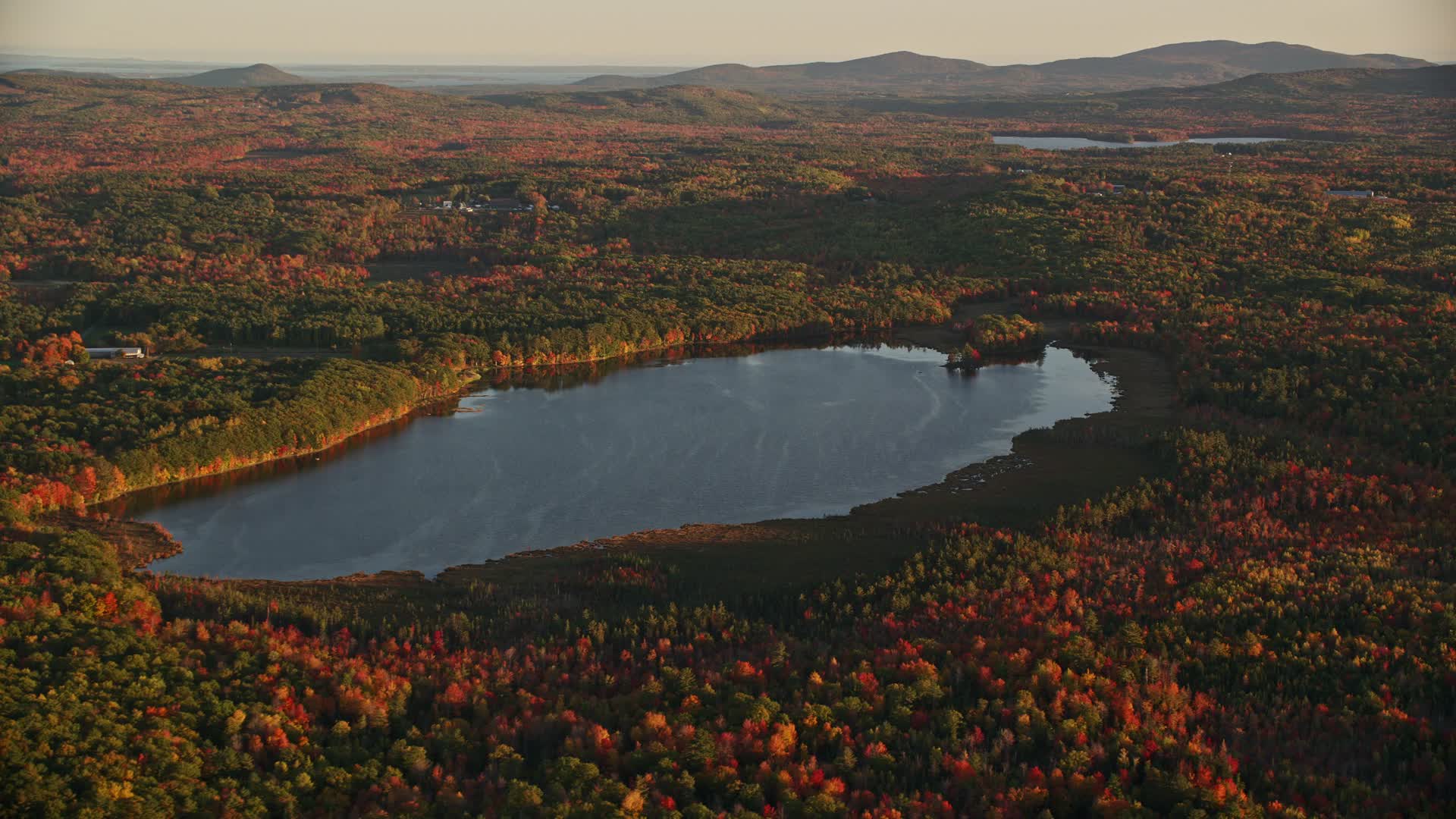 5.5K stock footage aerial video flying by Cross Pond, forest in autumn