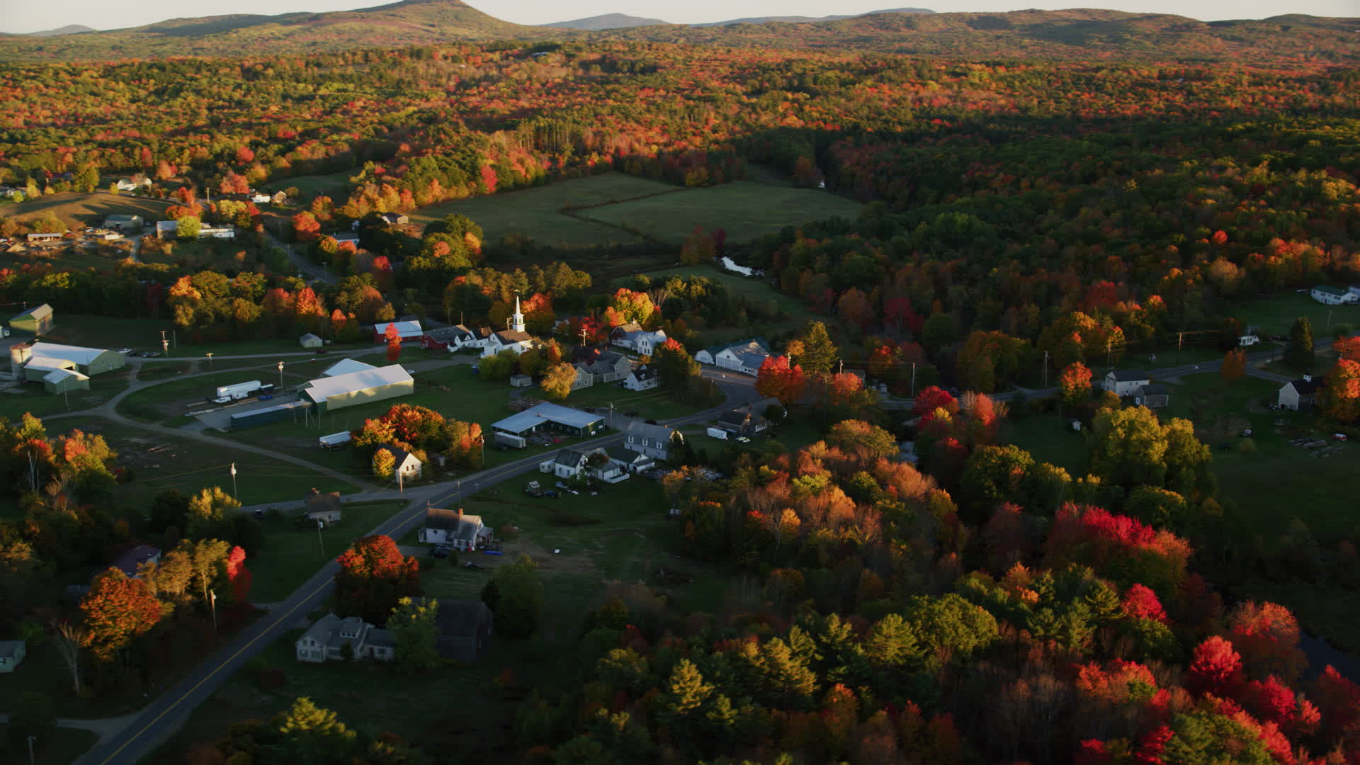 5.5K stock footage aerial video orbiting small rural town near colorful