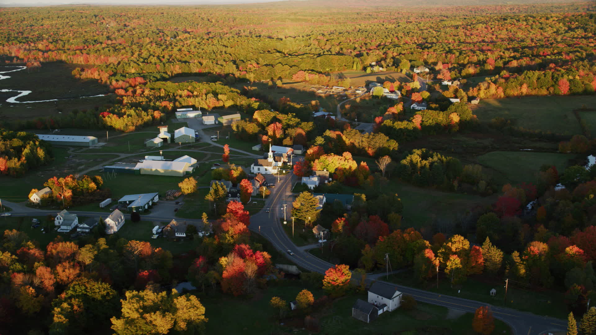 5.5K stock footage aerial video orbiting a small rural town in autumn