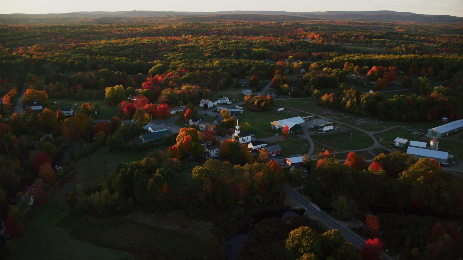 6K stock footage aerial video orbiting a small rural town and trees in