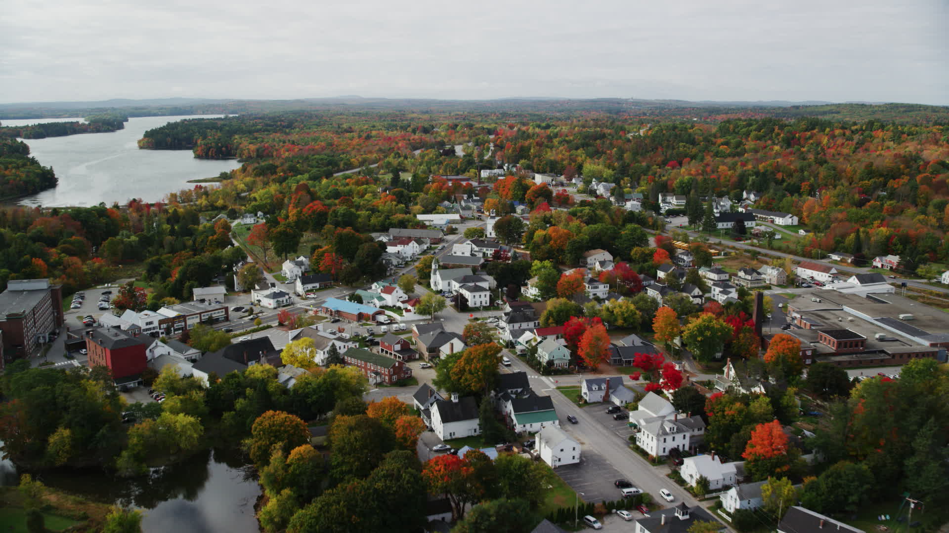 5.5K stock footage aerial video flying over small town homes, Main Street, tilt down, autumn
