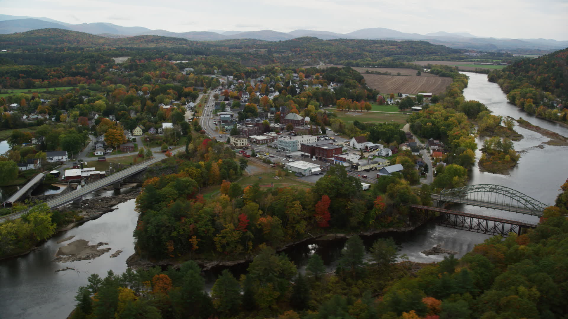 5.5K stock footage aerial video flying by rural town, bridge