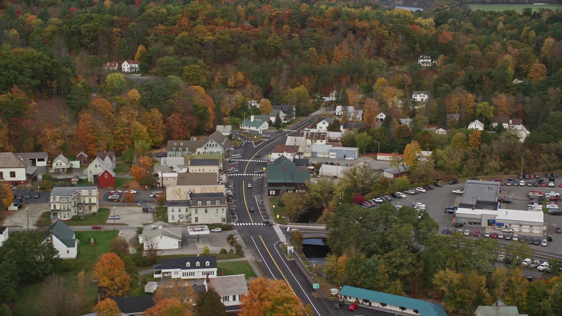 5.5K stock footage aerial video flying by small rural town, tilting up